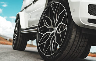 The White 2020 Mercedes G-Wagon is outfitted with Custom Aftermarket Vossen HF-2 Wheels in Brushed Gloss Black finish.